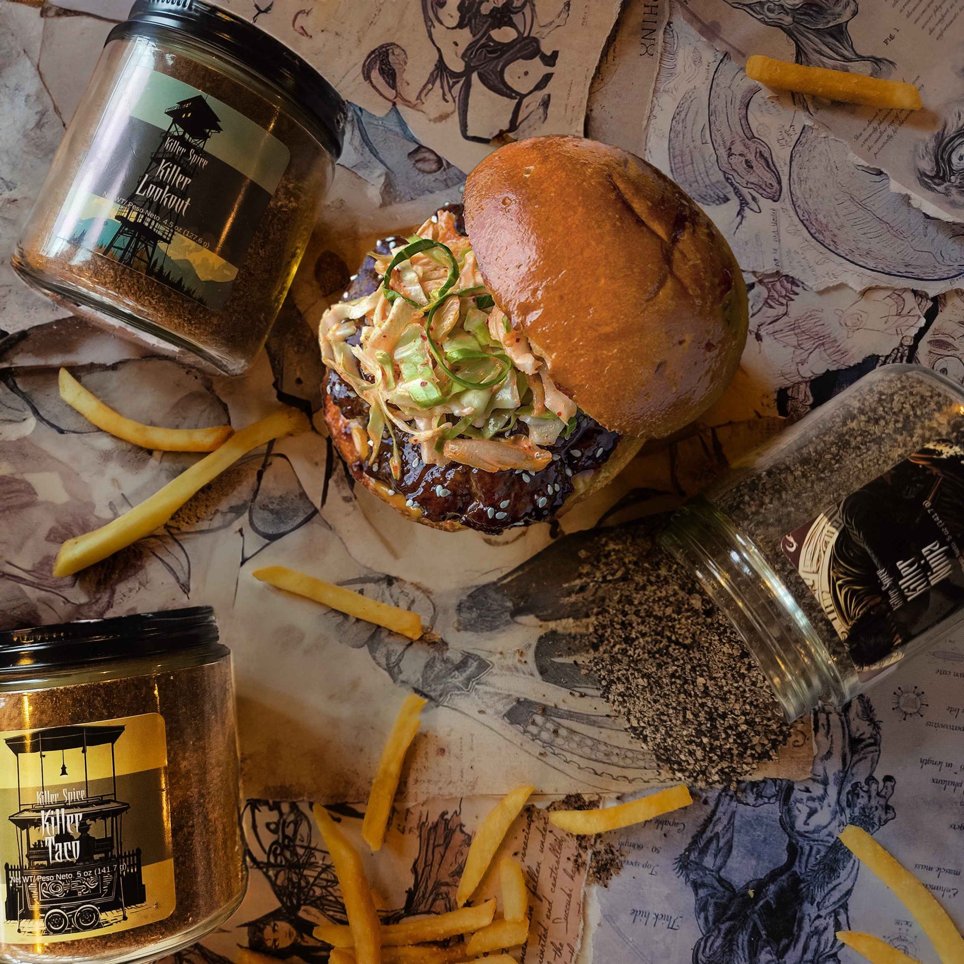 Killer Taco spice jar displayed with juicy burger topped with slaw and french fries on illustrated paper background