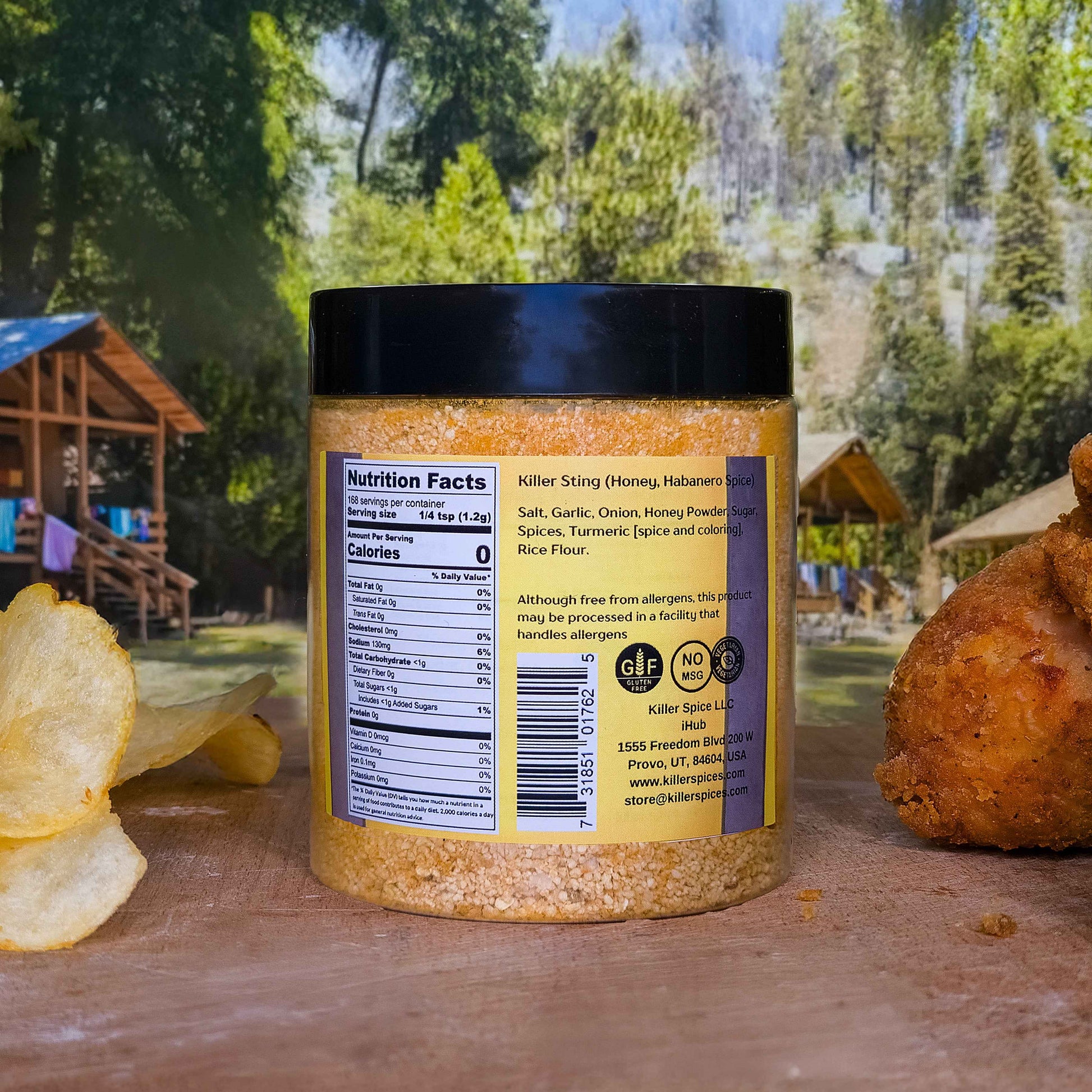 Killer Sting honey habanero spice blend jar showing nutrition facts label against outdoor picnic setting with chips