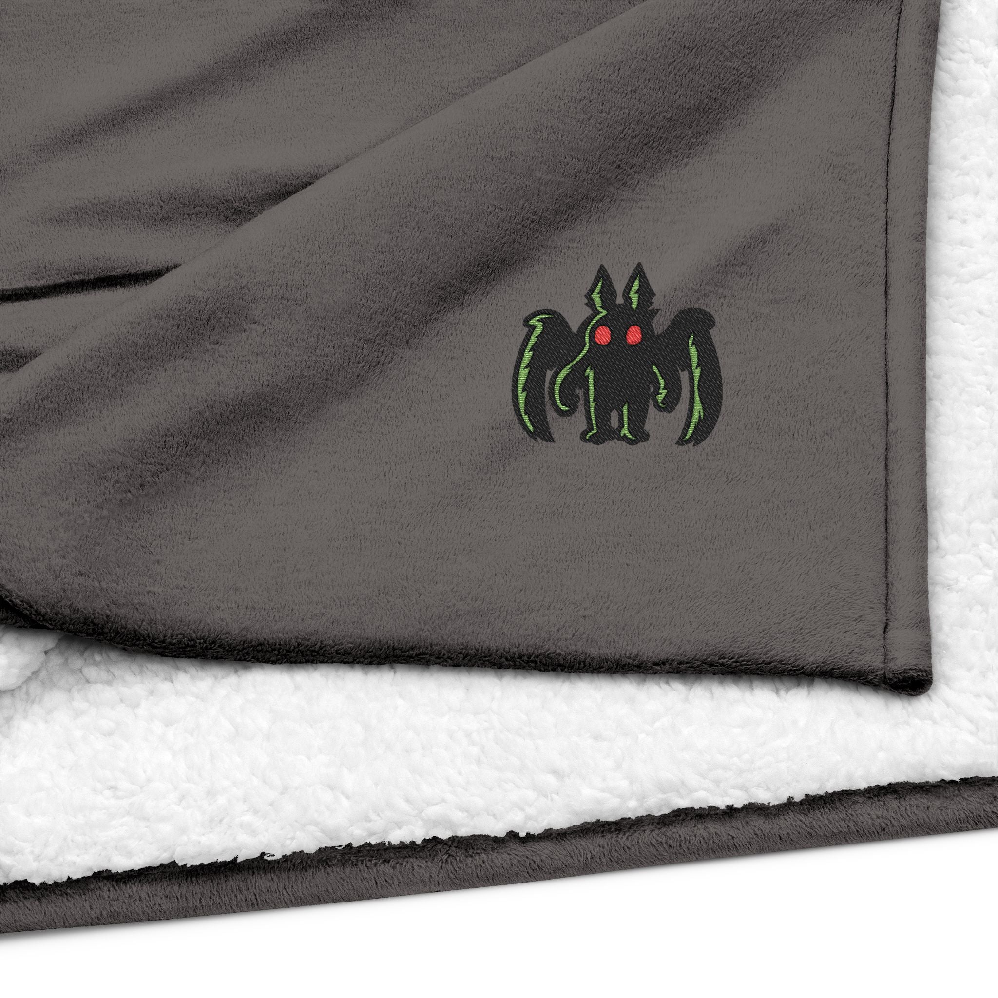 Embroidered Mothman Sherpa Blanket — Cozy Fleece Throw with Green Monster Logo
