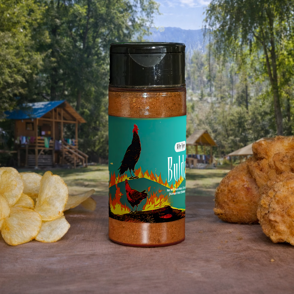Spice jar with a scenic label on a wooden surface with chips and bread, outdoors.
