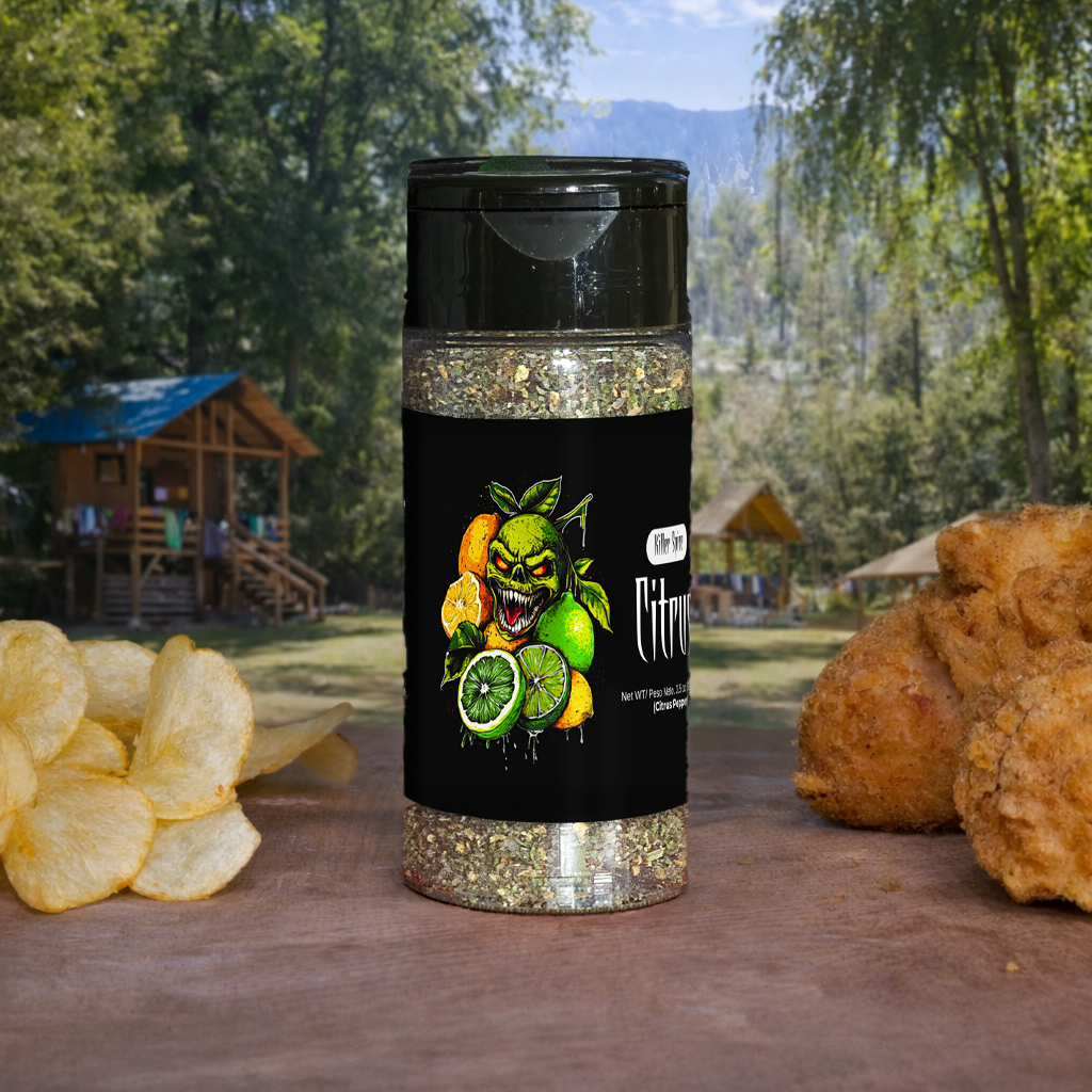 Spice container with a colorful label featuring a green monster face and fruit on a wooden surface with snacks in the background.