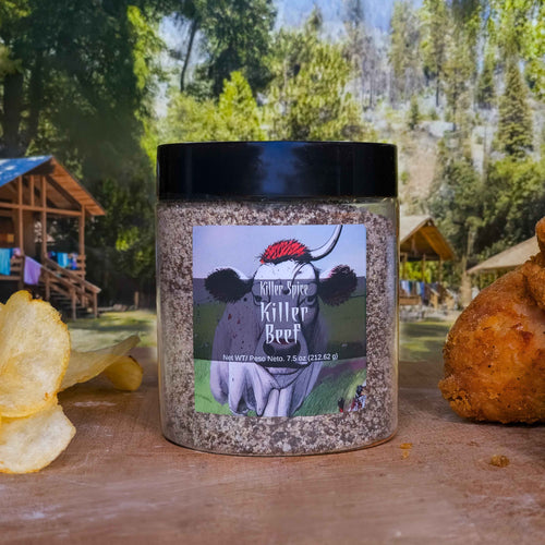 Killer Beef seasoning jar with coffee-garlic rub blend displayed with potato chips against outdoor woodland background