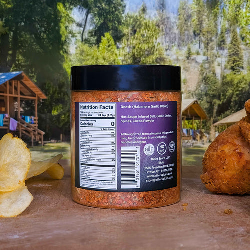 Death Chocolate Habanero spice blend jar showing nutrition facts label against outdoor woodland background with potato chips
