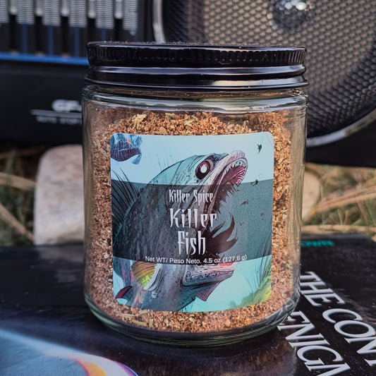 A jar of Killer Fish seafood seasoning blend with a label featuring an illustration of a fish and the words "gourmet experience killer spice, killer fish.