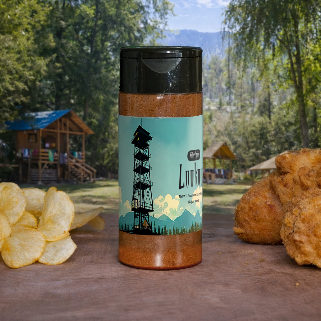 Spice container with a scenic label on a wooden surface with chips and bread, outdoors.