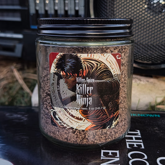 A jar of "Killer Ninja" black garlic and Kona coffee grounds spice blend on a table.