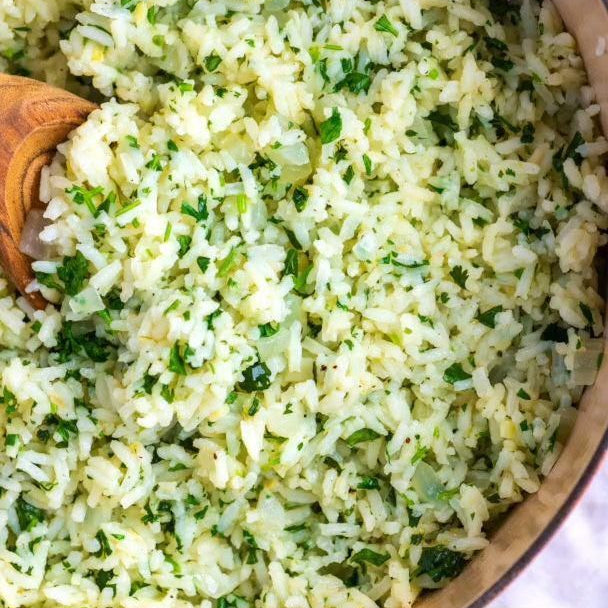Cilantro lime rice in a bowl with a wooden spoon