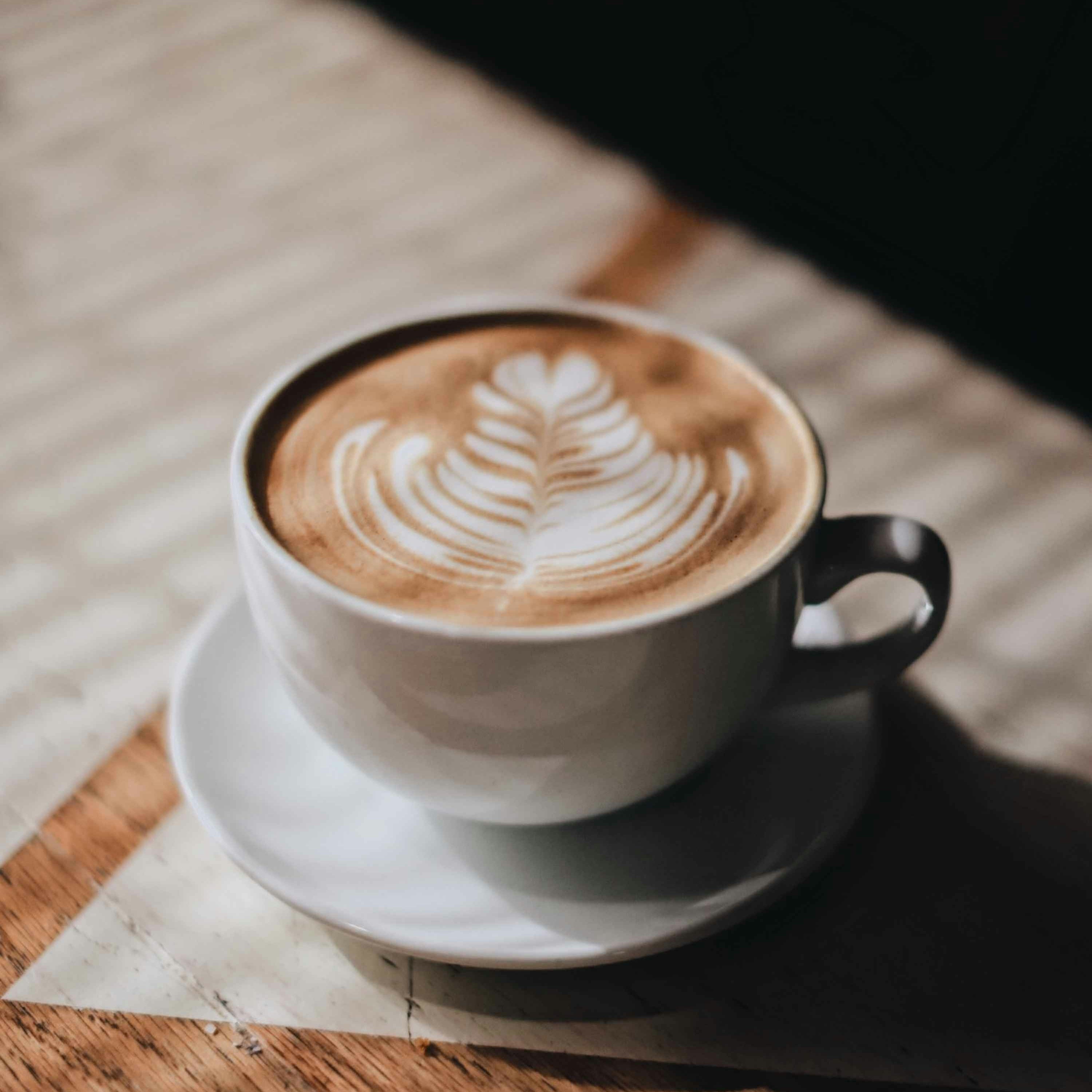 Cappuccino with latte art on a wooden table